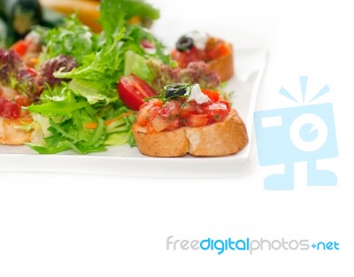 Original Italian Fresh Bruschetta Served With Fresh Salad And Ve… Stock Photo