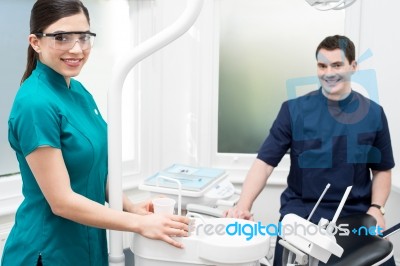 Orthodontist With Female Assistant In Clinic Stock Photo