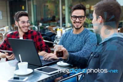 Outdoor Portrait Of Young Entrepreneurs Working At Coffee Bar Stock Photo