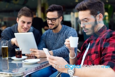 Outdoor Portrait Of Young Entrepreneurs Working At Coffee Bar Stock Photo