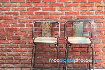 Outdoor Steel Chair On Red Brick Wall Stock Photo