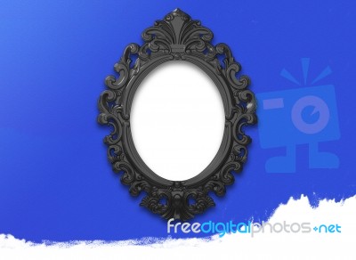 Oval Black Picture Frame With A Decorative On Blue Wall Stock Image