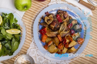 Oven Baked Meat With Potatoes, And Watercress Salad Stock Photo