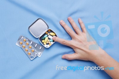 Pain From Illness With Hand Trying To Take Pills Stock Photo