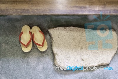 Pair Of Japanese Traditional Shoe On Stone Floor Stock Photo