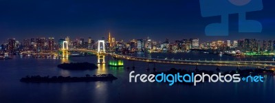 Panorama Of Tokyo Cityscape And Rainbow Bridge At Night Stock Photo