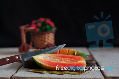 Papaya And Knife On Wooden Stock Photo