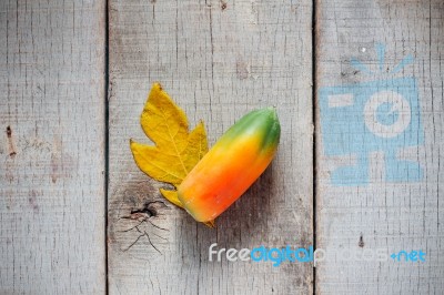 Papaya And Leaves On Wooden Stock Photo