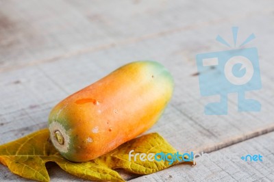 Papaya On Wooden Floor Stock Photo