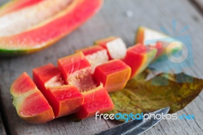 Papaya Slices On Wooden Stock Photo