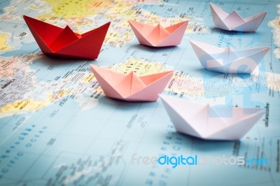 Paper Boats Following A Red Leader Boat Stock Photo