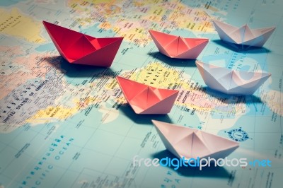 Paper Boats Following A Red Leader Boat Stock Photo