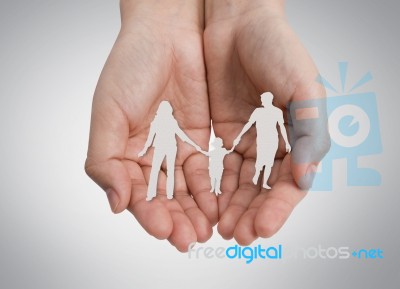 Paper Cut Of Family On Hand Stock Photo