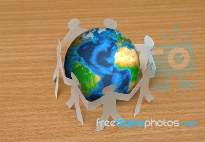 Paper Cut Of People Standing In A Circle Around Globe Stock Photo