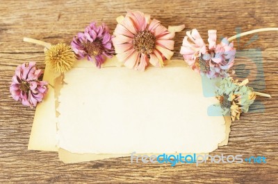 Paper Sheets And Flowers On Wooden Table Stock Photo