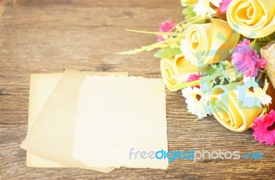 Paper Sheets And Invent Flowers On Wooden Table Stock Photo