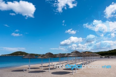 Parasols At Liscia Ruja Beach In Sardinia Stock Photo