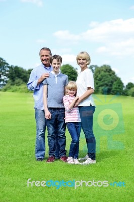 Parenst With Chidren Is Having Fun In The Park Stock Photo