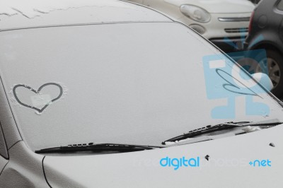 Parked Car Covered With The First Snow In Winter Stock Photo