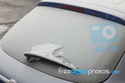 Parked Car Covered With The First Snow In Winter Stock Photo