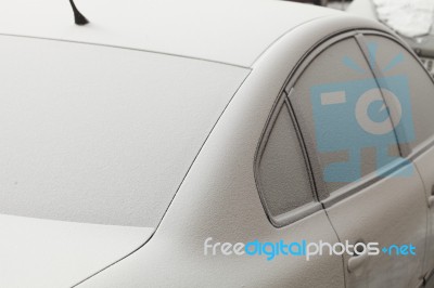 Parked Car Covered With The First Snow In Winter Stock Photo