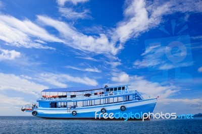 Passenger Wooden Boat Floating On Blue Sea Water With Beautiful Stock Photo