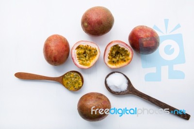 Passion Fruit With Salt In Wooden Spoon On Wooden White Backgrou… Stock Photo