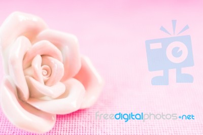 Pastel Rose (ceramic ) On Pink Fabic Background Stock Photo