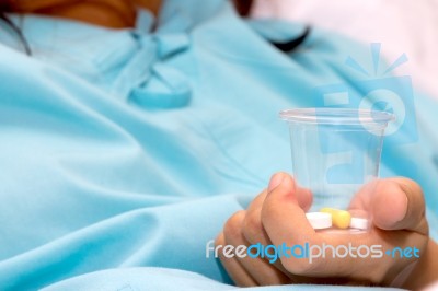 Patient With Pill In Hands Stock Photo