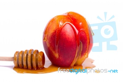 Peach With Honey Dipper Stock Photo