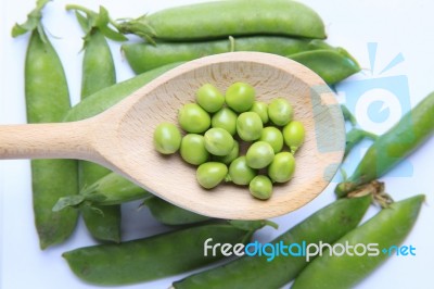 Peas On Wooden Spoon Stock Photo