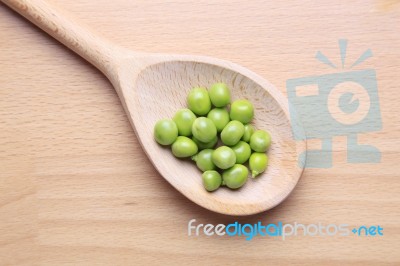 Peas On Wooden Spoon Stock Photo