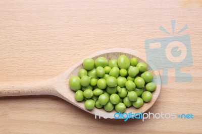 Peas On Wooden Spoon Stock Photo