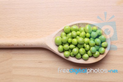 Peas On Wooden Spoon Stock Photo