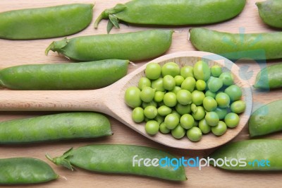 Peas On Wooden Spoon Stock Photo