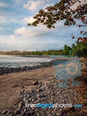 Pebble Beach By The Sea With Cloudy Sky Stock Photo