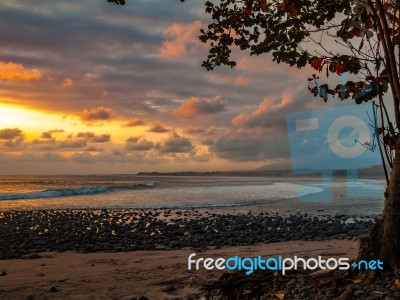 Pebble Beach By The Sea With Cloudy Sky Stock Photo