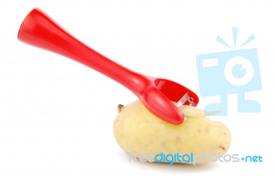 Peeling A Potato With Peeler On White Stock Photo