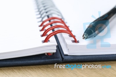 Pen And Blank Opened Notebook Stock Photo