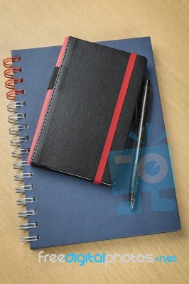 Pen And Notebook On Wooden Table Stock Photo