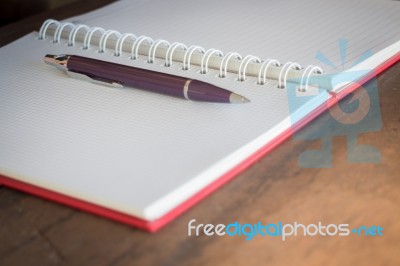 Pen And Noteboook Paper On Wooden Table Stock Photo