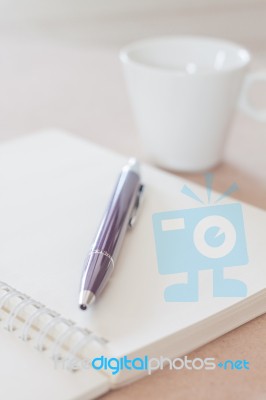 Pen And Spiral Notebook With Coffee Cup Stock Photo