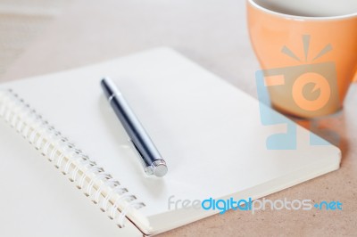 Pen And Spiral Notebook With Coffee Cup Stock Photo