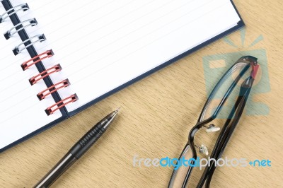 Pen, Glasses And Blank Opened Notebook On The Table Stock Photo