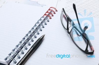 Pen, Notebook, Glasses And Financial Report Stock Photo