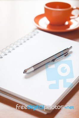 Pen On Open Blank White Notebook With Coffee Cup On The Desk Stock Photo