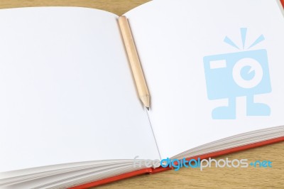 Pencil And Blank Opened Notebook Stock Photo