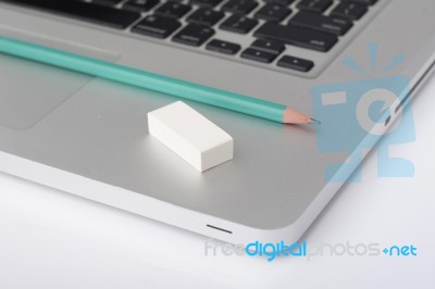 Pencil And Eraser On The Laptop Stock Photo