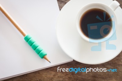 Pencil On Open Blank Notebook With Coffee Cup Stock Photo