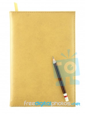 Pencil On Yellow Leather Notebook Stock Photo